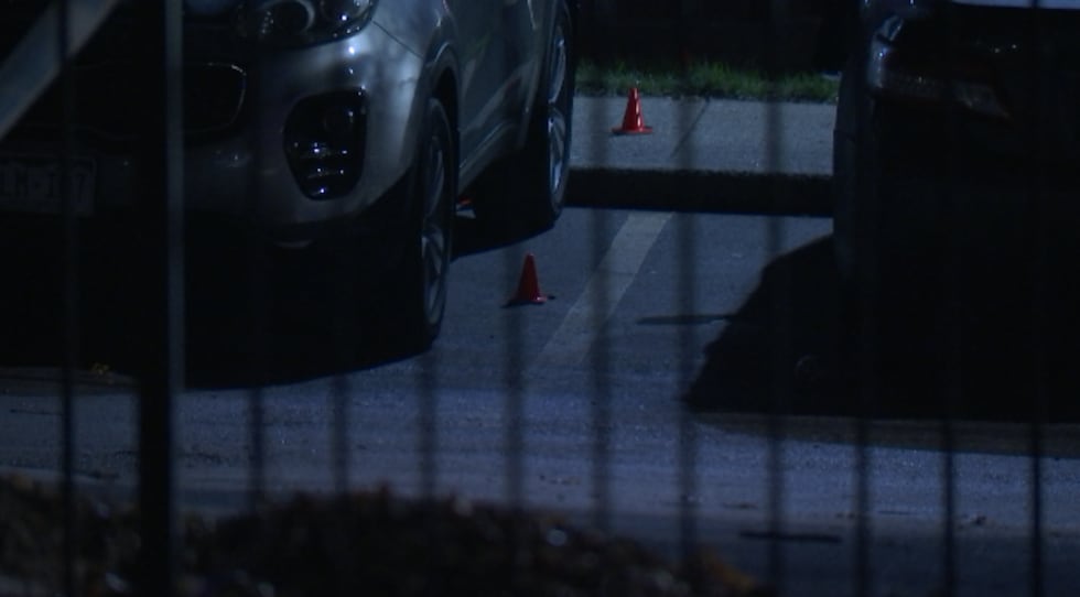 Evidence markers lay in the parking lot of an apartment complex in the 6000 block of Blue...