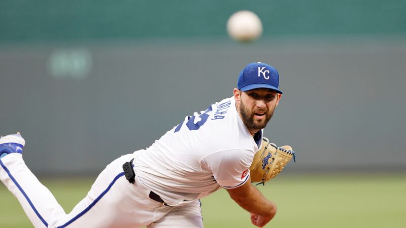 Kansas City Royals pitcher Michael Wacha watches a throw to a Cleveland Guardians batter...