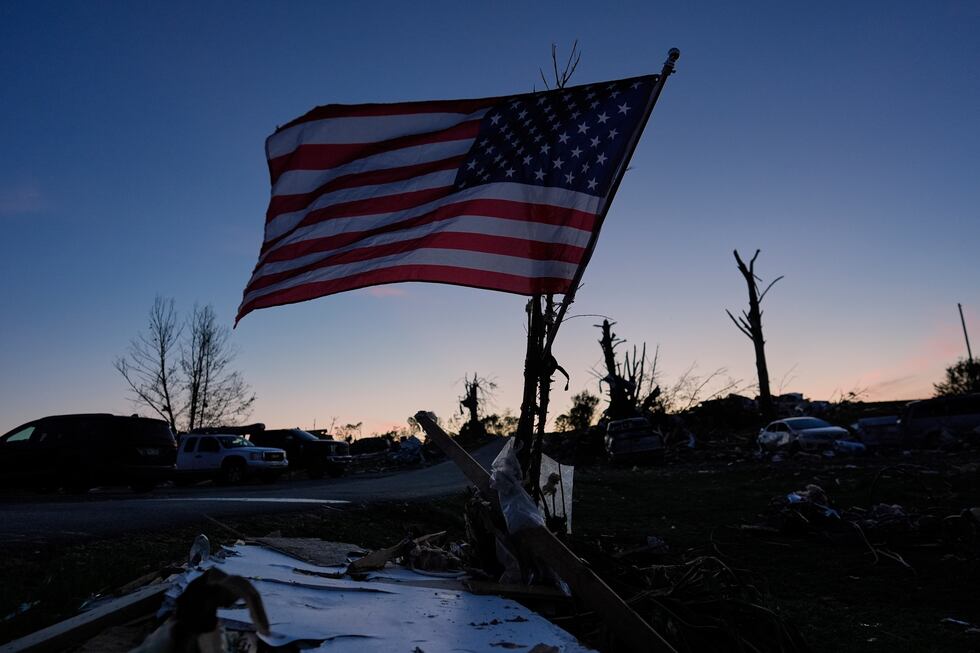 An American Flag is posted near destroyed homes after a tornado ed through the area,...