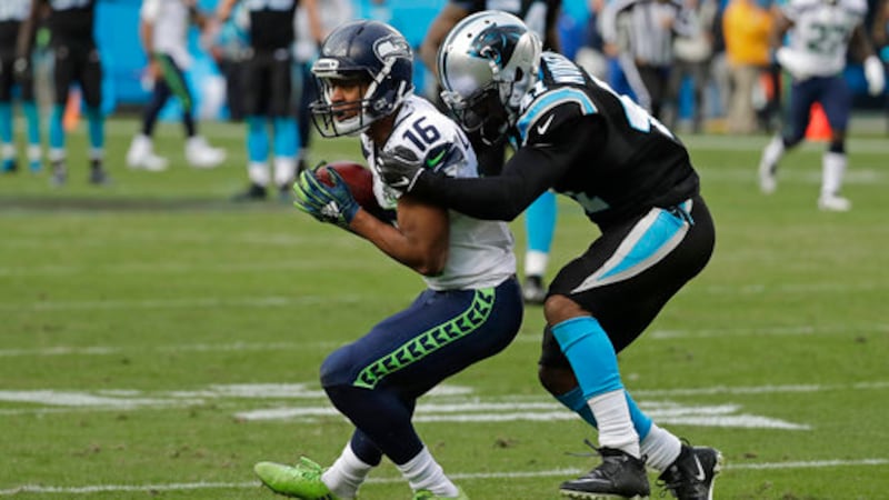 Seattle Seahawks' Tyler Lockett (16) catches a against Carolina Panthers' Captain...