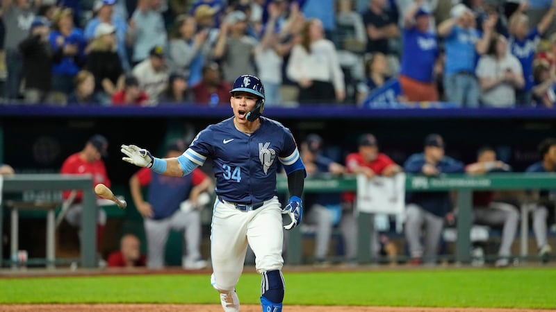 Kansas City Royals' Freddy Fermin celebrates as he runs to first after hitting an RBI single...