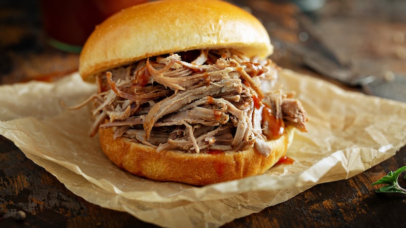 Pulled pork sandwich on a soft brioche bun with bbq sauce and pickles