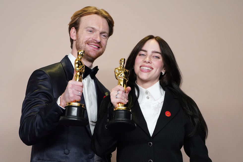 Finneas O'Connell, left, and Billie Eilish pose in the press room with the award for best...