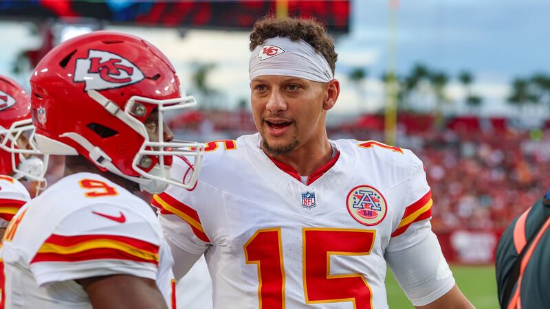 Kansas City Chiefs quarterback Patrick Mahomes (15) talks with running back Kenneth Walker III...