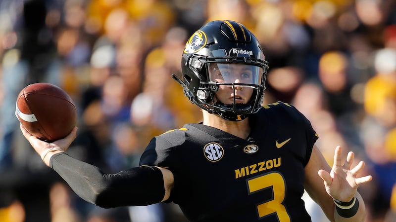 Missouri quarterback Drew Lock passes during the first half of an NCAA college football game...