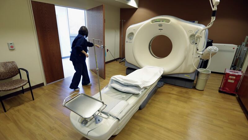 FILE - In this Jan. 9, 2013, file photo, a CT scan technician prepares for a patient at the...