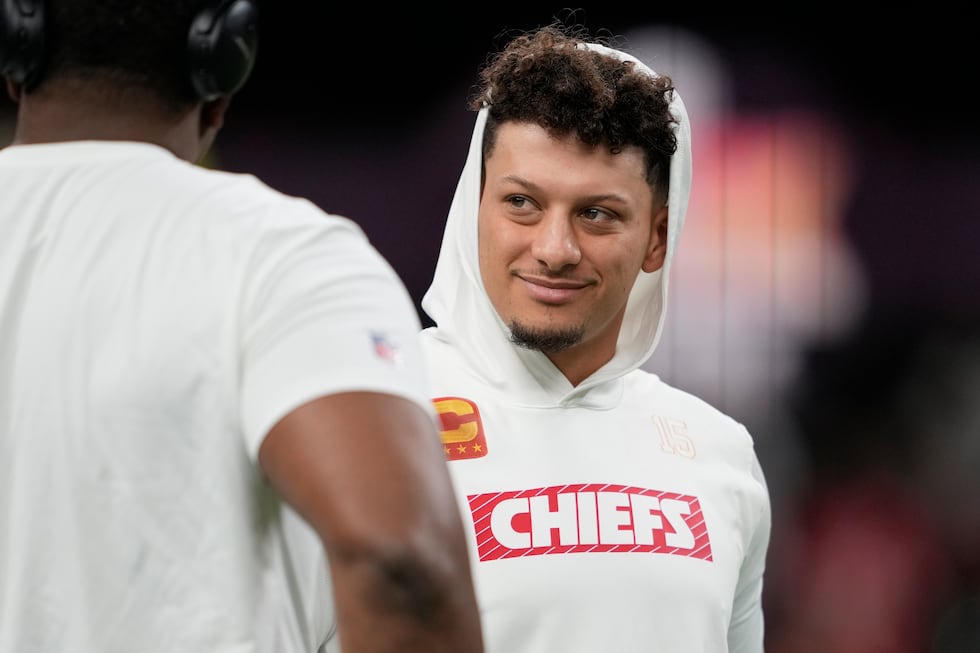 Kansas City Chiefs quarterback Patrick Mahomes talks with a member of the Philadelphia Eagles...