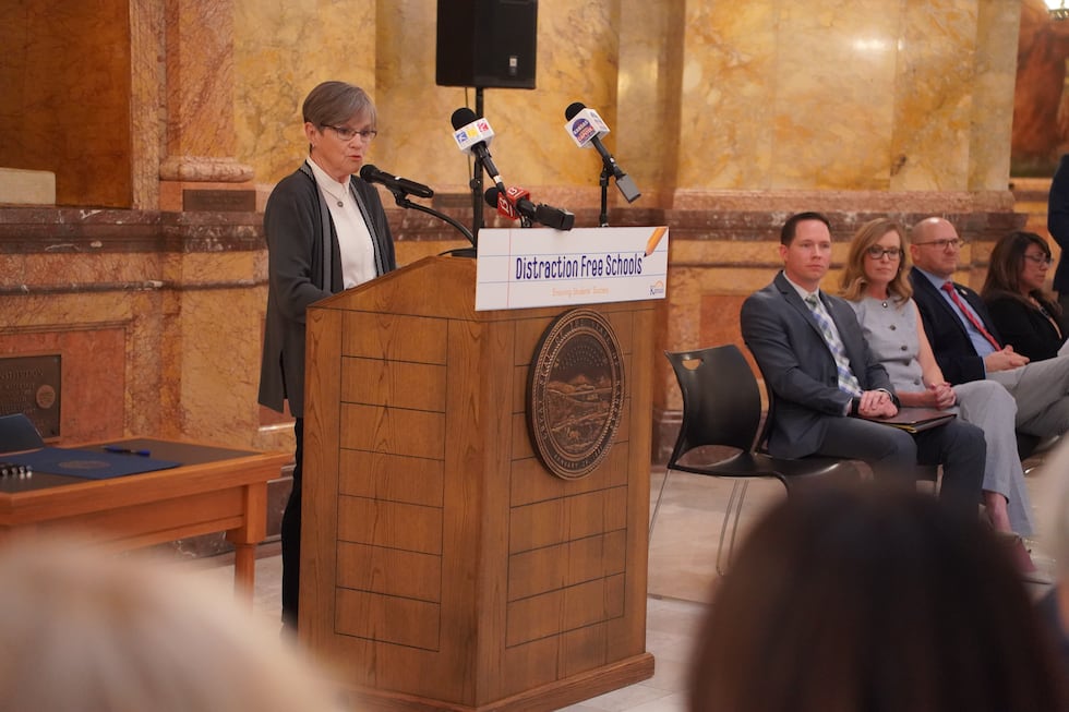 Governor Laura Kelly signs the state's new bell-to-bell cellphone ban into law on March 19, 2026.