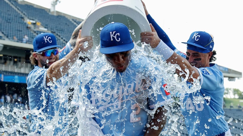 Kansas City Royals' Tyler Tolbert (2) is doused by Carter Jensen, left, and Josh Rojas (40) at...