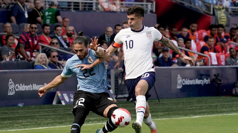 Uruguay defender Martin Caceres (4) and USA forward Christian Pulisic (10) chase the ball...
