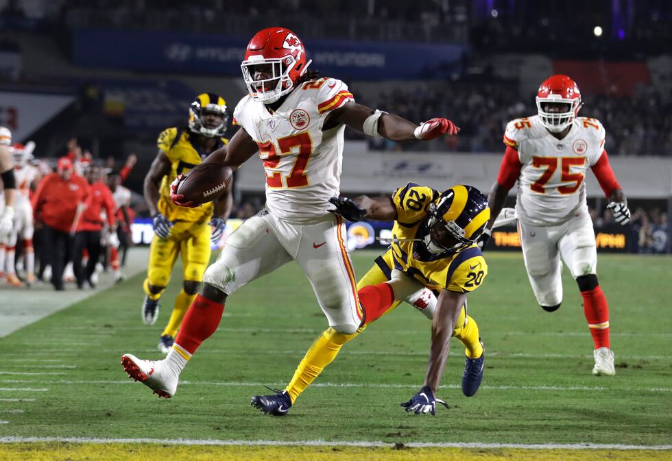 FILE - Kansas City Chiefs running back Kareem Hunt (27) scores a touchdown ahead of Los...