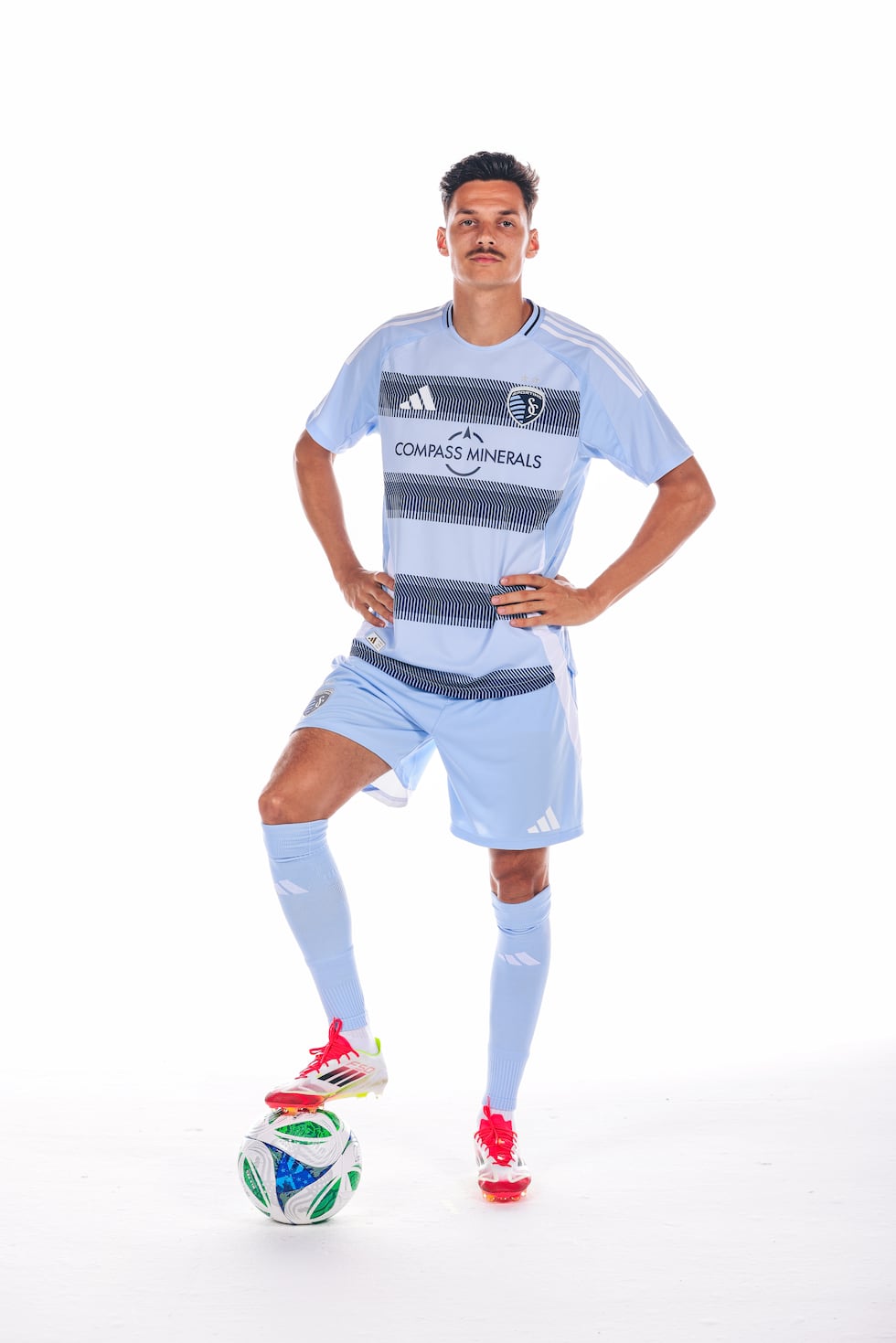 Sporting KC midfielder Daniel Salloi showcases the club's "One KC" uniforms.