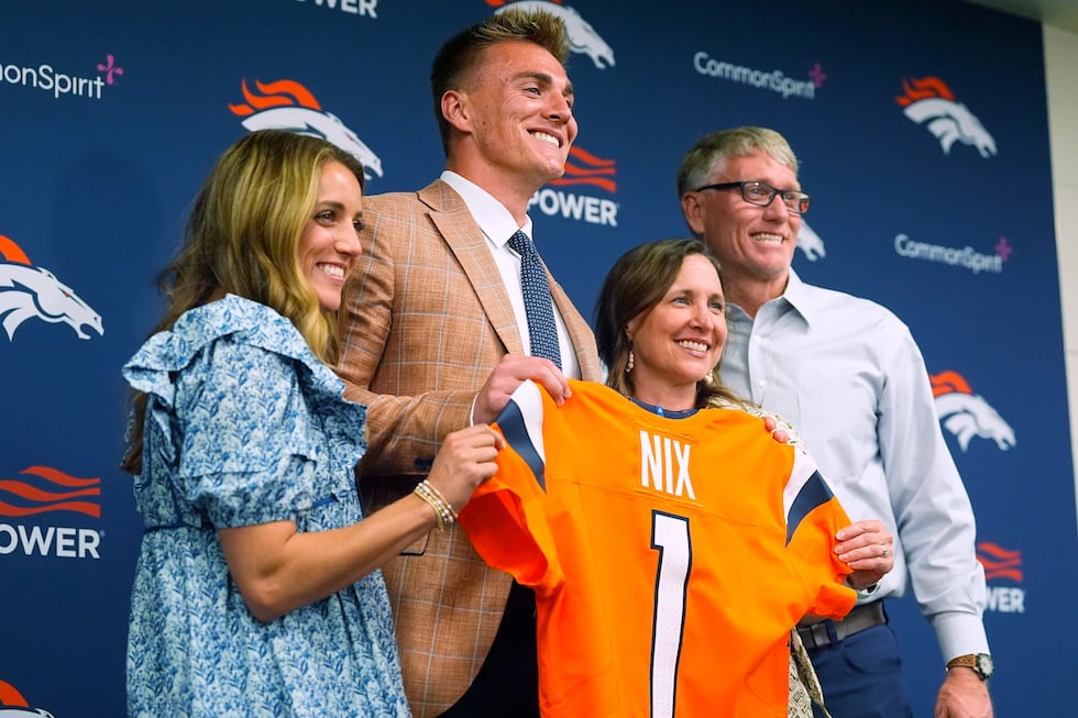 Denver Broncos draft pick quarterback Bo Nix, second from left; his wife, Izzy, left; and...