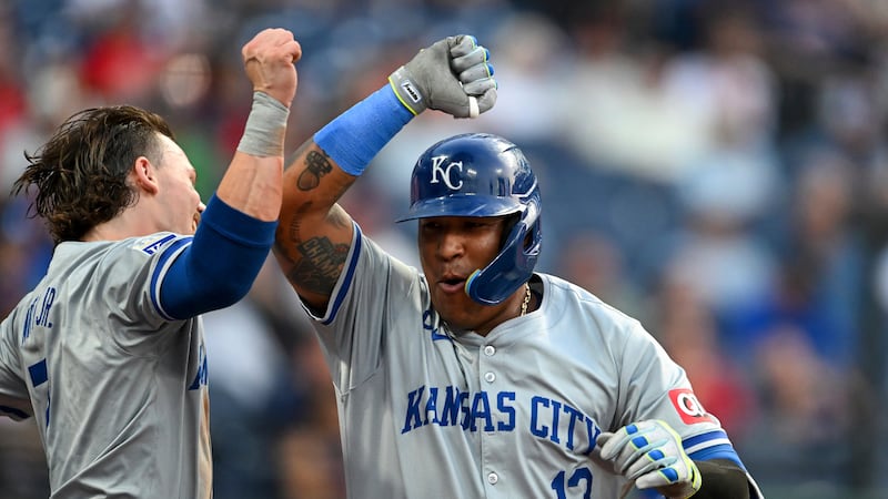 Kansas City Royals' Salvador Perez (13) and Bobby Witt Jr., left, celebrate after a solo home...