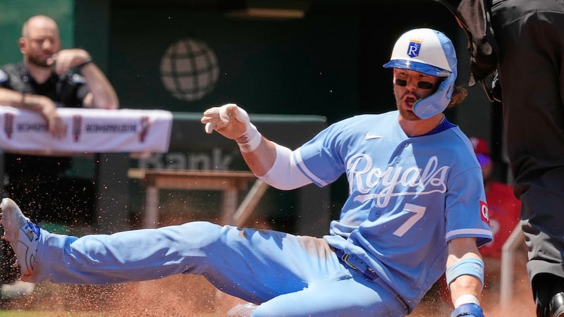 Kansas City Royals' Bobby Witt Jr. slides home to score on a double by Lane Thomas during the...