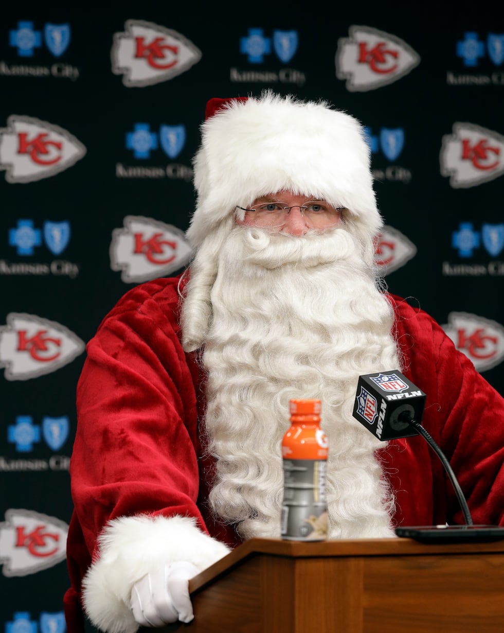 Kansas City Chiefs head coach Andy Reid wears a Santa costume during a news conference...
