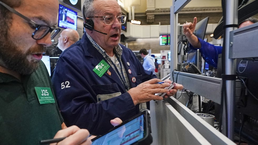 Options traders Serge Marinovich, left, and Phil Phil Fracassini work on the floor of the New...