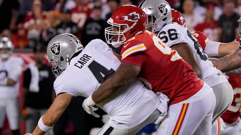 Las Vegas Raiders quarterback Derek Carr (4) is sacked by Kansas City Chiefs defensive tackle...