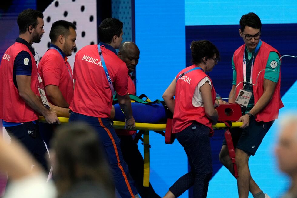 Slovakia’s Tamara Potocka is taken on stretcher from the pool deck after collapsing following...