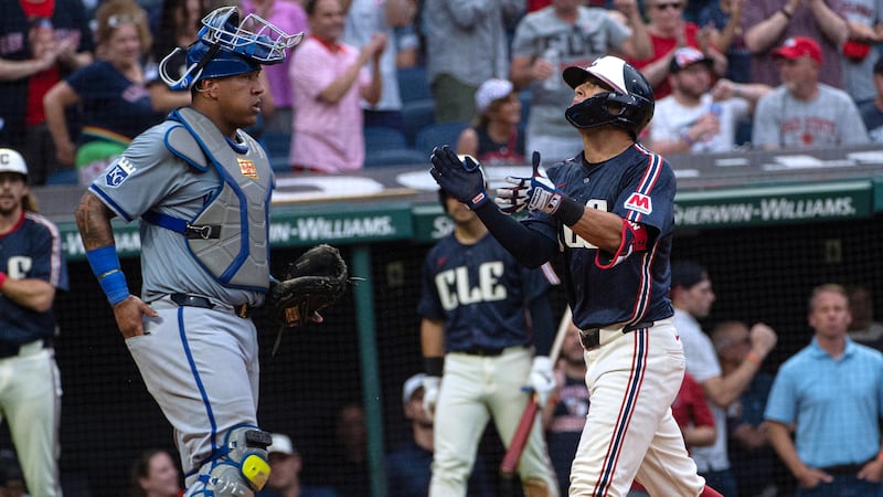 Cleveland Guardians' Tyler Freeman, right, celebrates his two-run home run off Kansas City...