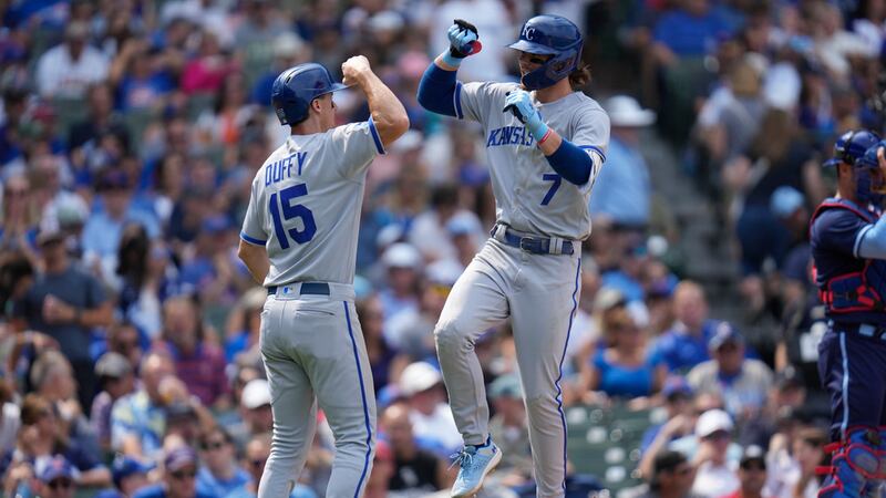 Kansas City Royals' Bobby Witt Jr., right, jumps up to celebrate his home run with Matt Duffy...