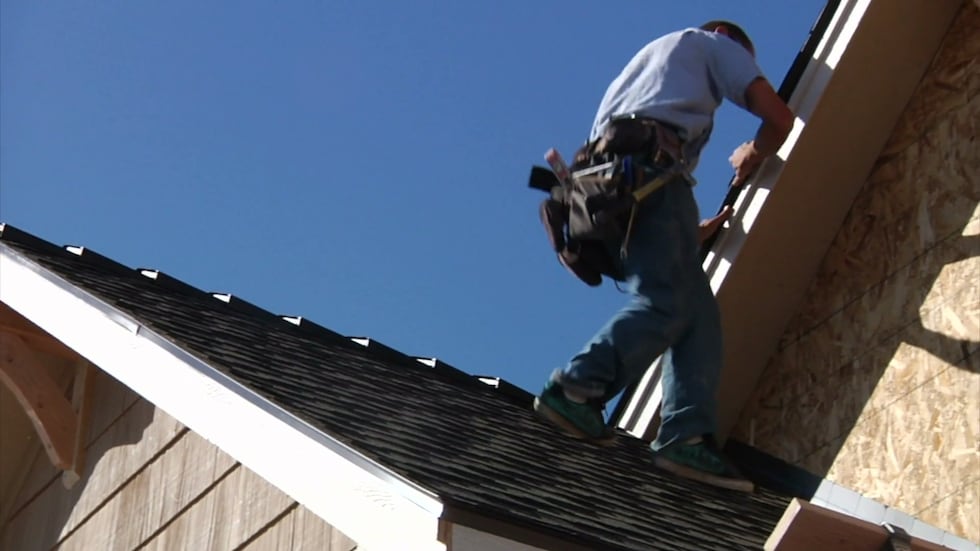 FILE - Roofers