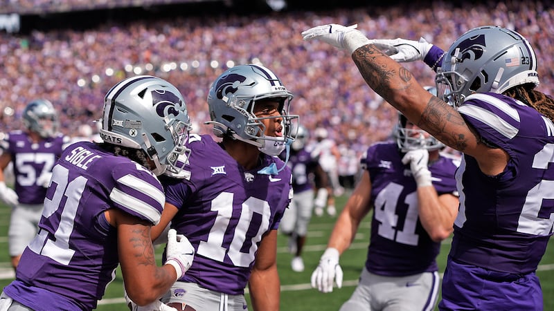 Kansas State cornerback Jacob Parrish (10) celebrates with teammates after intercepting a pass...