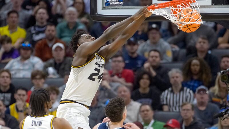Missouri guard Kobe Brown (24) dunks the ball over Utah State defenders during the second half...