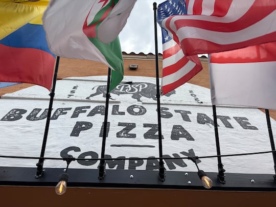 Flags wave outside of Buffalo State Pizza in Kansas City, Missouri during the World Cup.